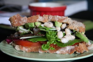white bean salad on whole wheat bread with avocado 